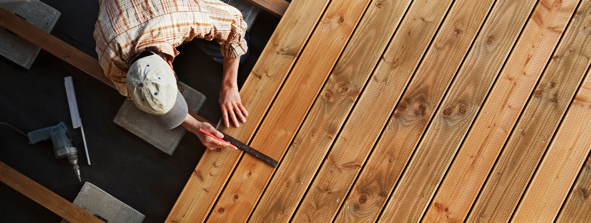 Man building an outdoor wooden deck