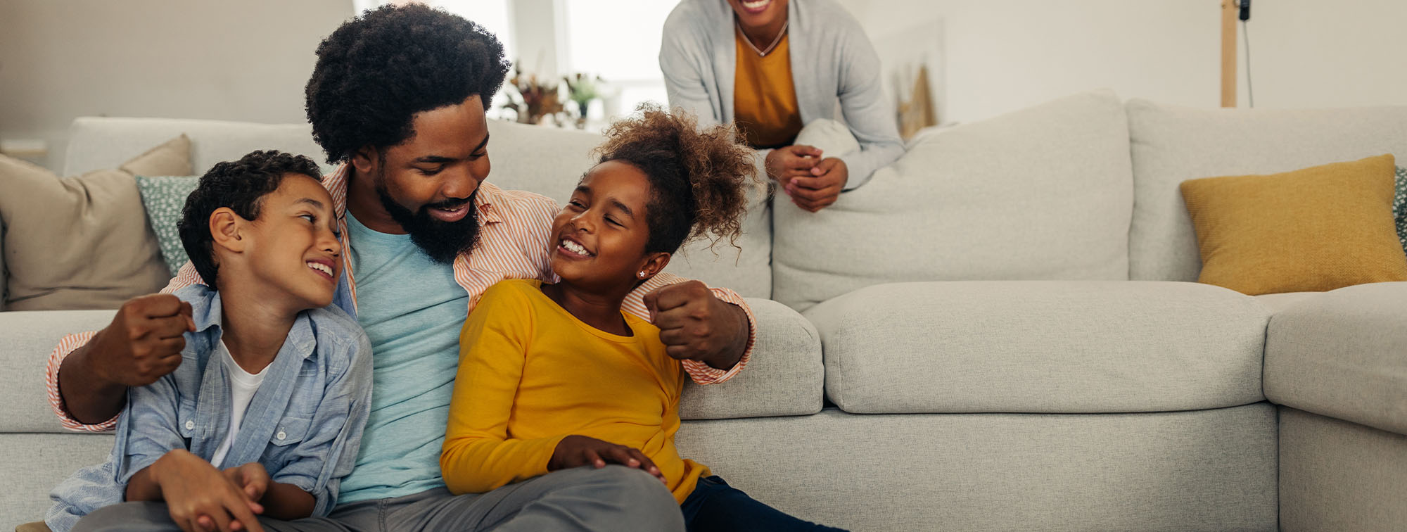 Father and two children spending time together at home