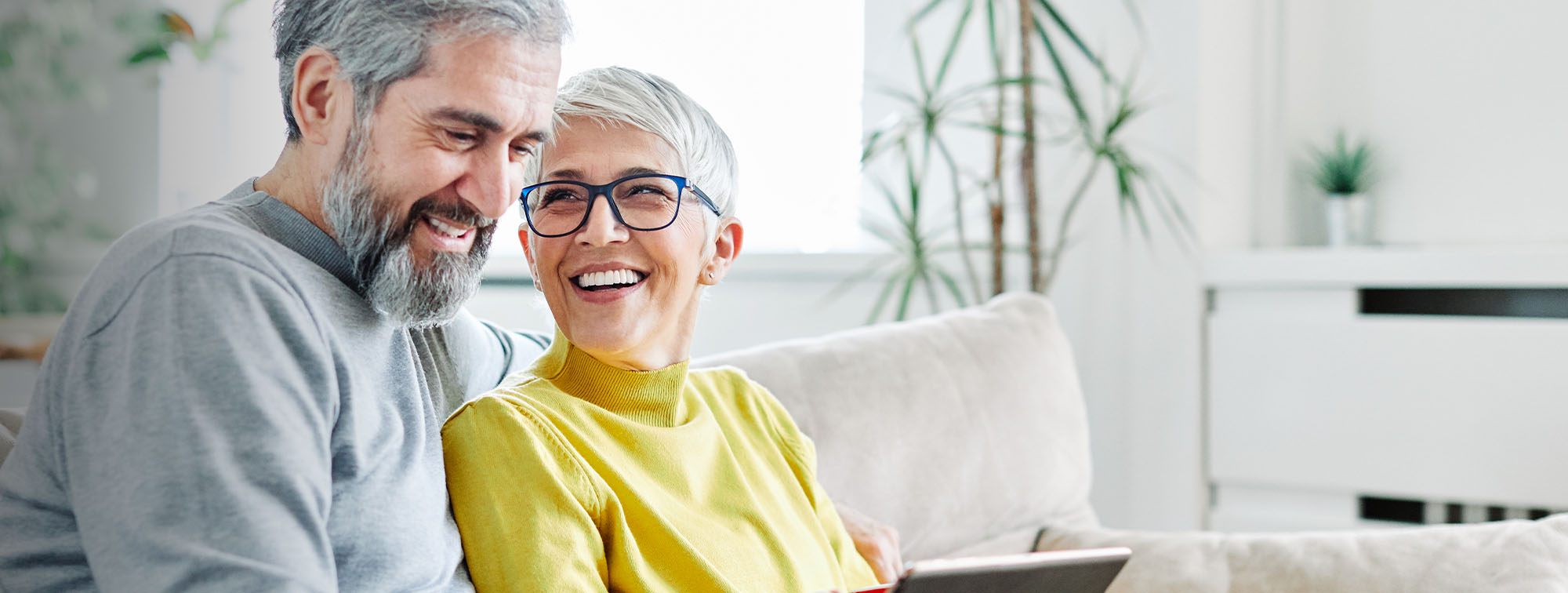 Older couple sitting together on a couch