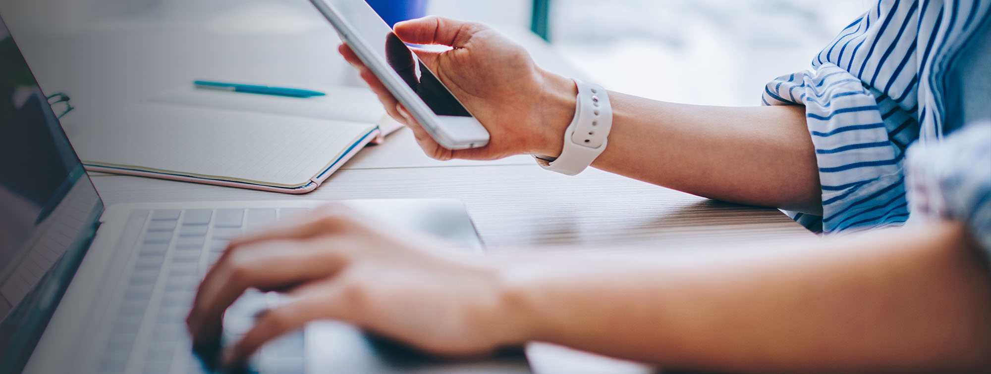 Person looking at payment options on their phone and computer