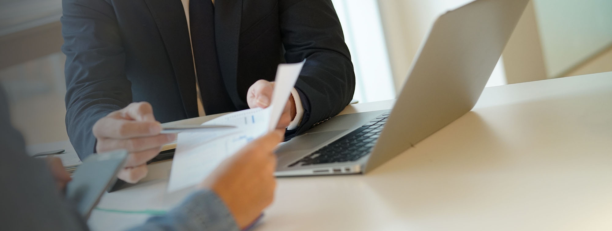 Two people analyzing paper documents