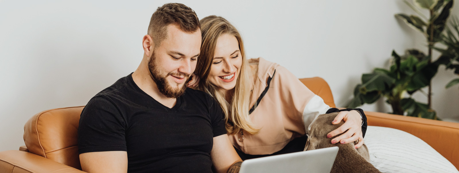 couple with dog on couch