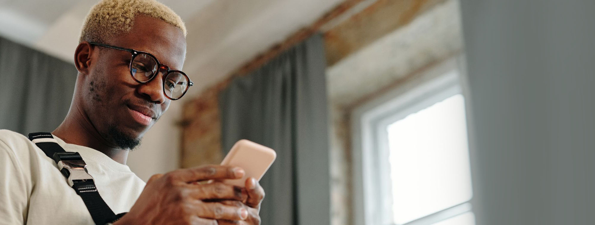 hip young male looking at cell phone