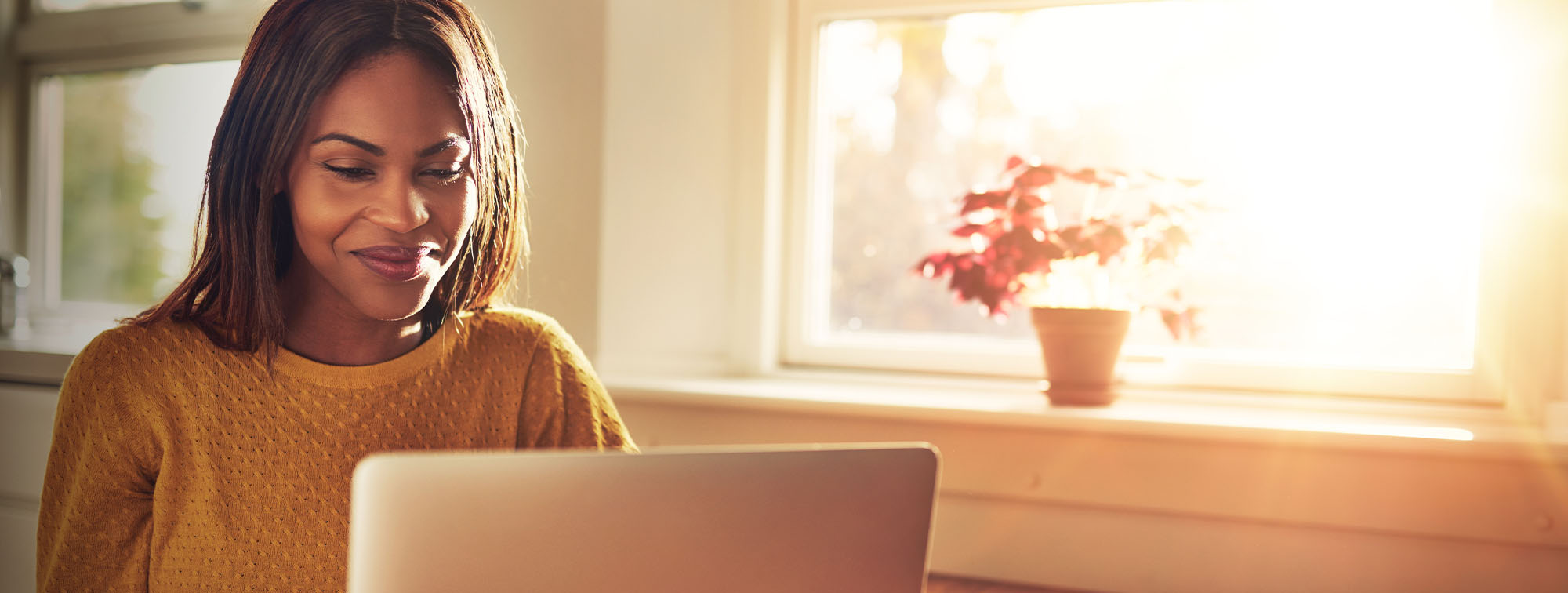 Woman smiling using her laptop