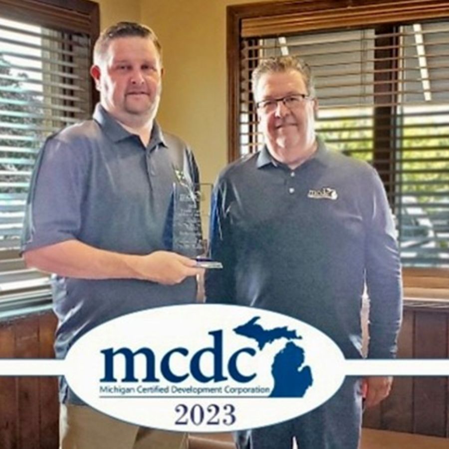 Matt Schroeder, Business Relationship Manager at Financial Plus, holds his Credit Union Lender of the Year award.