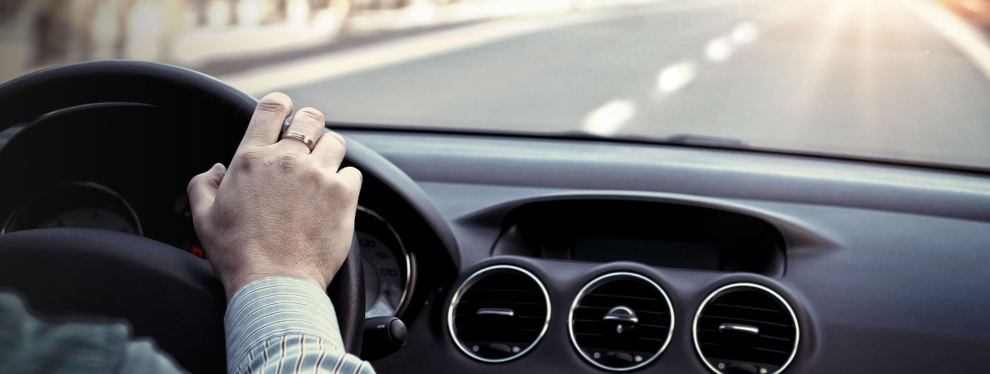 Image of vehicle dashboard while a person is driving