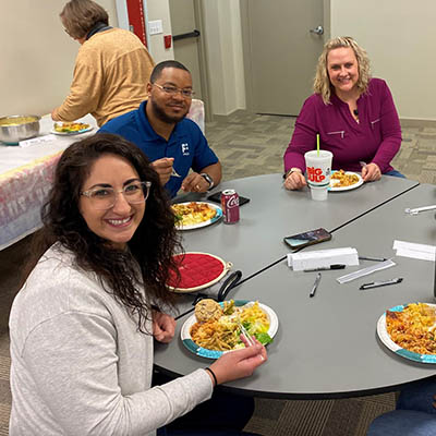 group of financial plus employees eating