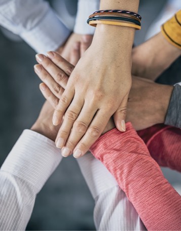 a group of hands piled in the center