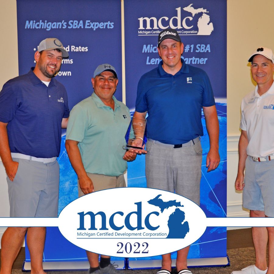 Financial Plus Credit Union representatives accepting MCDC's 2022 Credit Union of the Year award.