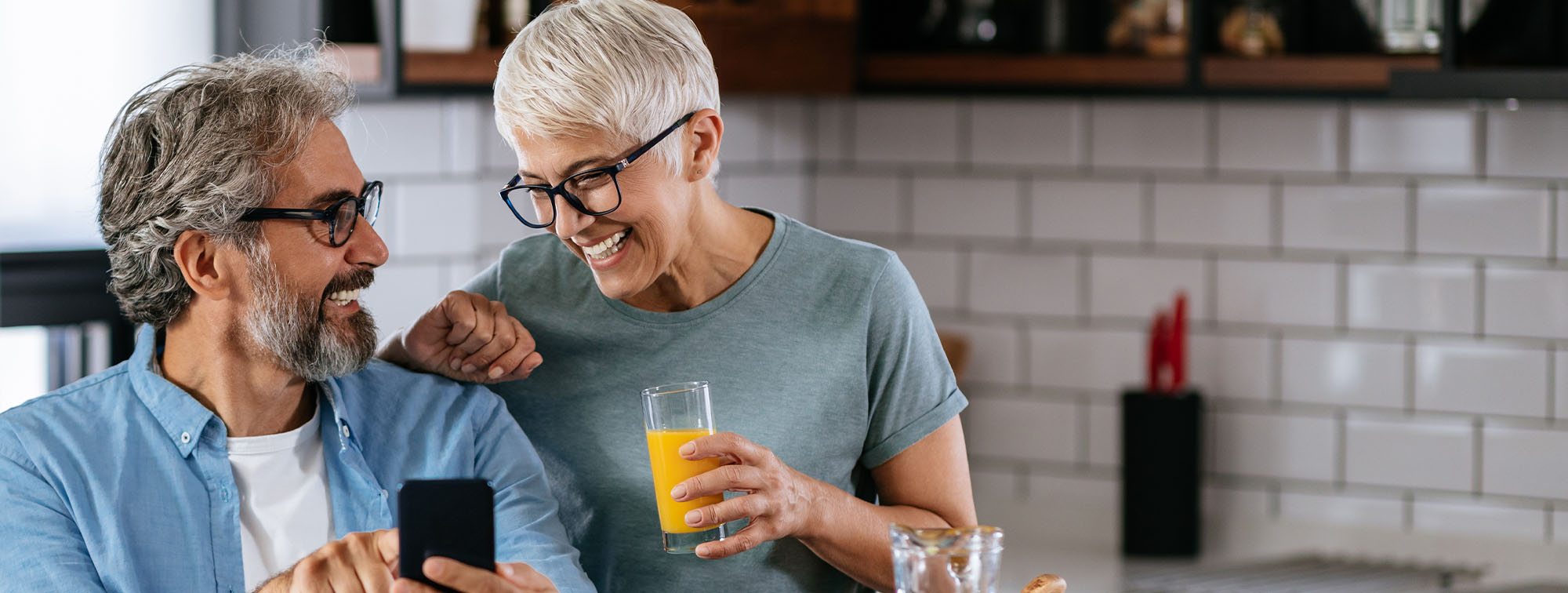 Couple looking at mobile device together