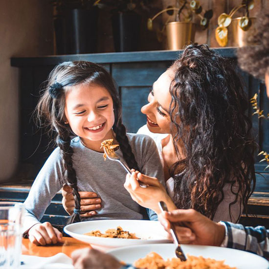 Mom and daughter eating dinner