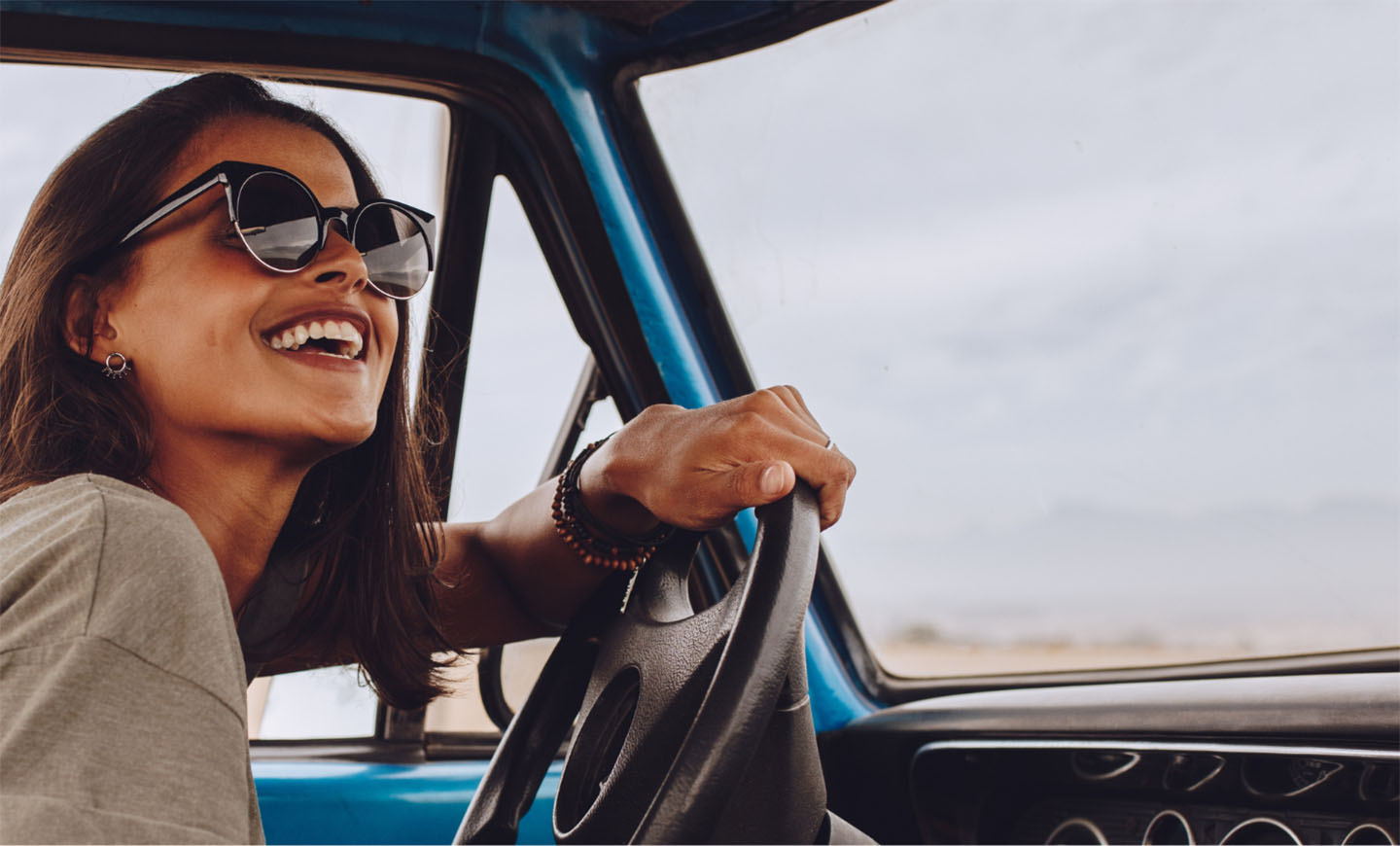 Woman driving blue truck