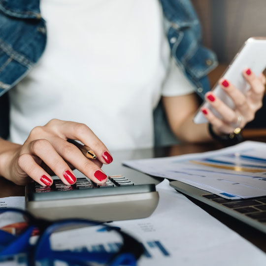Woman typing on a calculator